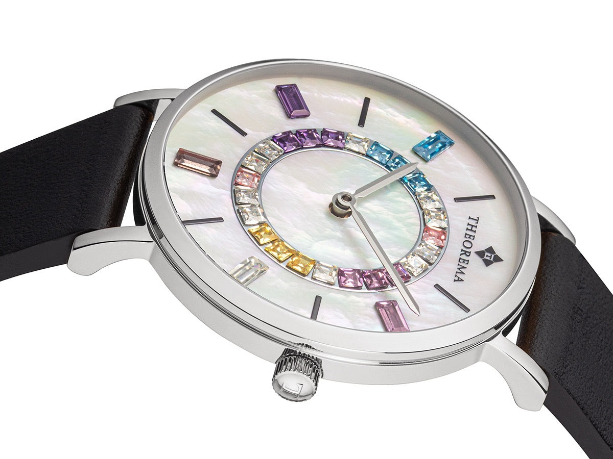 Two silver hands on a mother of the pearl dial in multi color design.