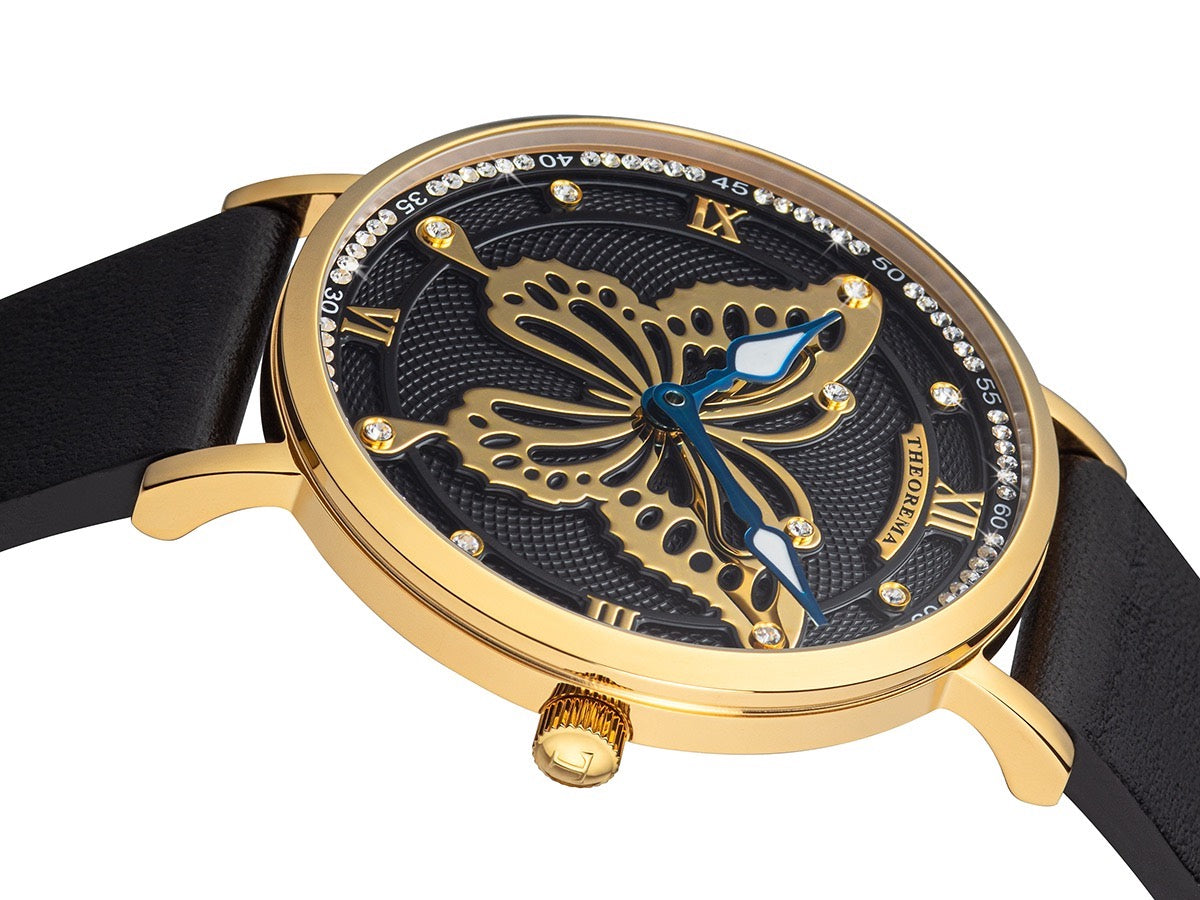 Two hands with leaf shape and a gold color butterfly design that covers most of the dial.