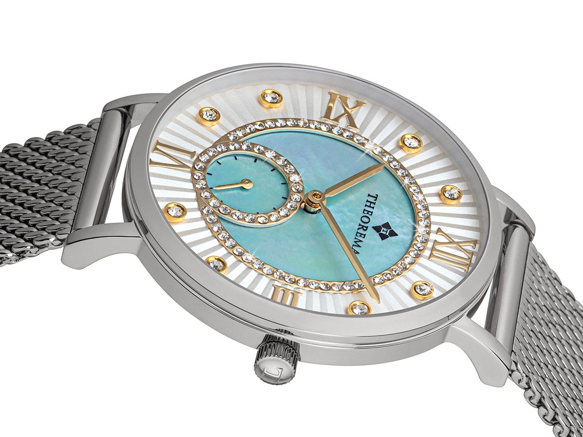 Multi tone dial with different shapes and the Theorema logo under 12 a clock.