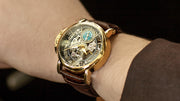 Wrist shot photo of the Made in Germany Casablanca Theorema watch with gold case and brown leather mechanical skeleton for men