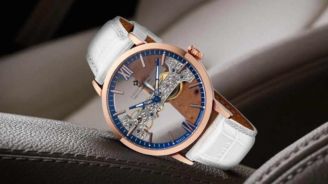 Tufina Theorema San Francisco, a limited edition men's mechanical watch with a skeleton dial, rose gold case, Roman and stick numerals, skeleton two-colored hands and blue details