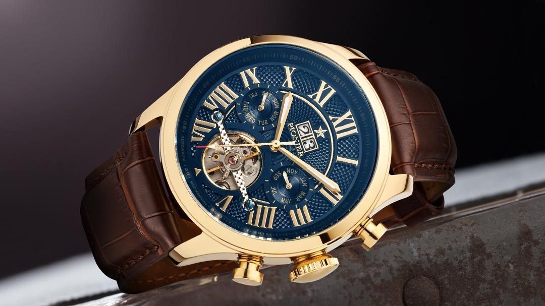 Tufina Pionier Havana, German calendar gold plated watch for men with a blue dial, open heart window and a brown leather band