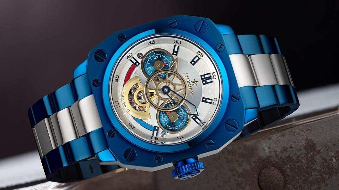 Tufina Pionier Newport Dual-time, German automatic watch for men with a blue and silver dial, metal bracelet, skeletonized hands and 5 ATM water resistance