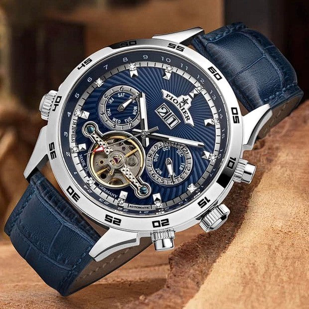 Blue dial watch with calendar and open-heart design.