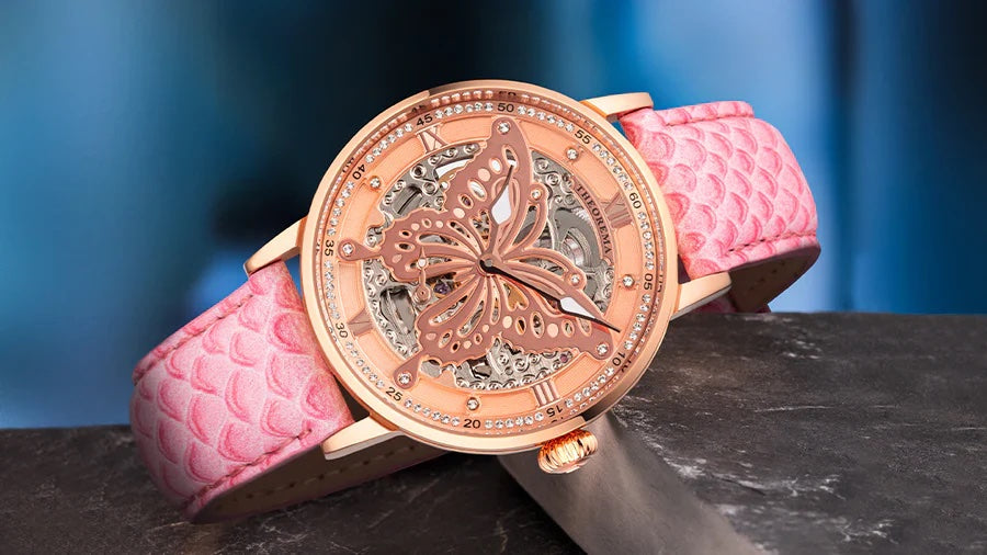 Pink watch for woman with a butterfly as a dial.