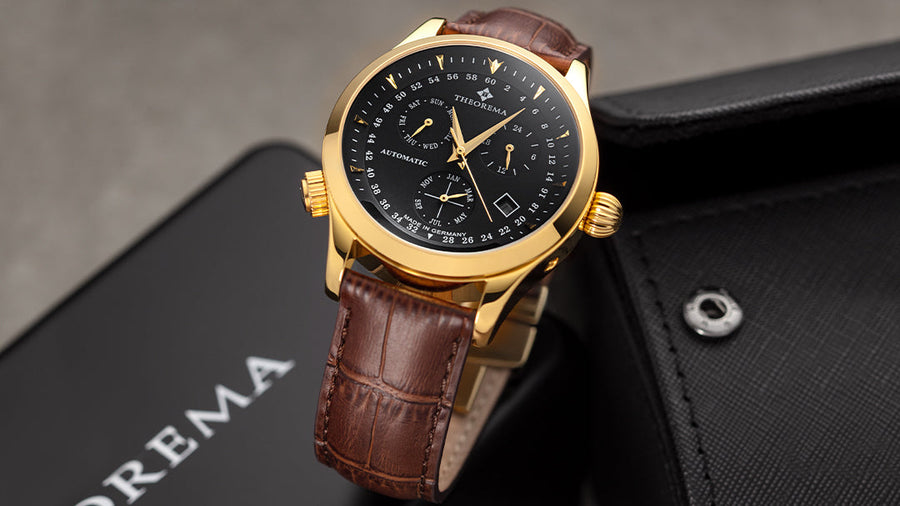 All black dial with a gold color case along a genuine leather brown band.