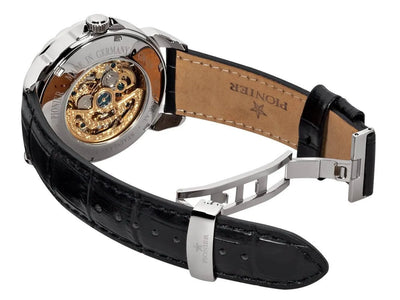 Open back case with gold mechanism visible gears and deployment buckle.