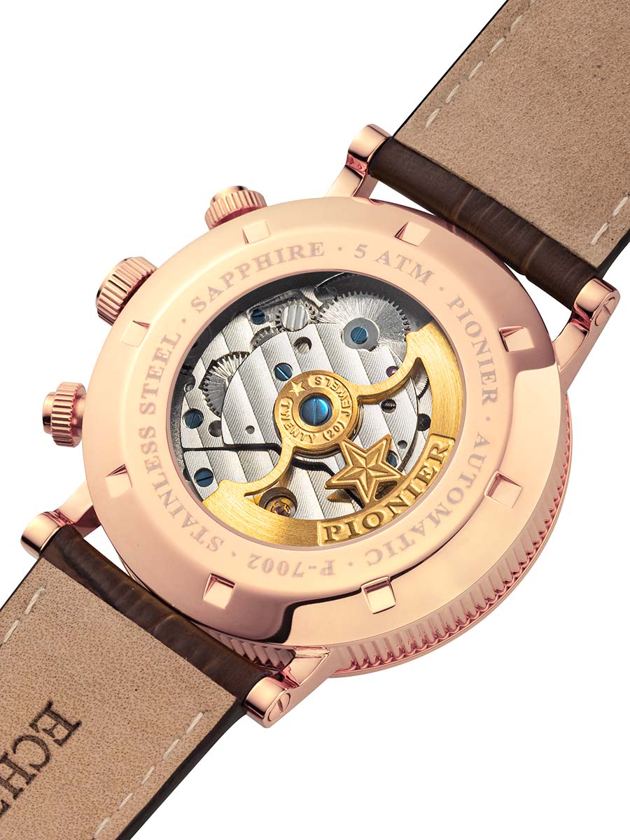 Rose gold Pionier watch with a visible mechanical movement on a dark brown strap.