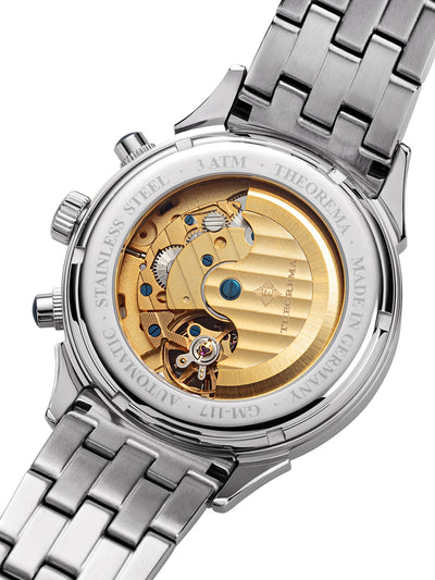 Open back case with gold mechanism and visible gears inside and a stainless steel band.