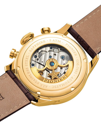 Gold watch with visible mechanical components on a brown leather strap
