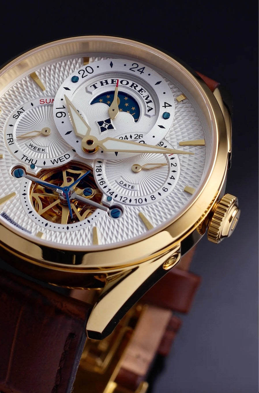 Open heart design with gold color movement in a white dal in a multi-tone design.